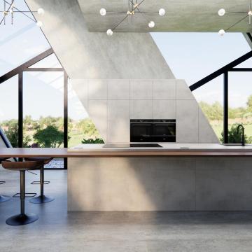 Cuisine loft ilot gris beton dekton et noyer